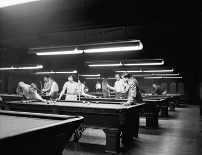 IMAGE:  Students shoot pool in the Reynolds Club billiards room, December 19, 1952. Lewellyn recalls positioning himself to see the most players through his lens. "They were really concentrating."