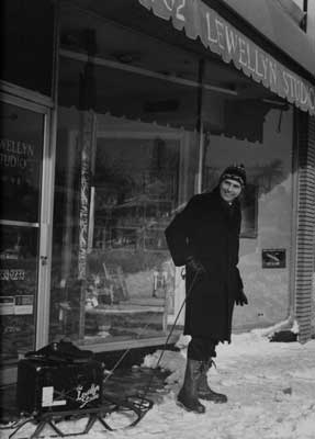IMAGE:  Lewellyn stands in front of his photography studio on 82nd and Cottage Grove, January 28, 1967. The Great Chicago Blizzard didn't prevent him from dragging his camera-on his son's sled-to shoot a wedding that went on despite the snow. 