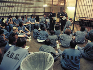 IMAGE:  Women in a Cook County holding cell await their sentencing trials. Chicago research shows that in 2000 almost 85 percent of women in Illinois state prisons were mothers.