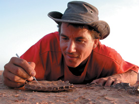 IMAGE: Paul Sereno examines a dinosaur’s jaw.