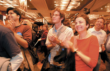photo:  Undergrads Amrit Mehra, Quinn Bernier, and Kristen Love cheer for early pro-Kerry returns.