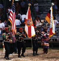 photo: A color guard of U.S. veterans (from left) Paul Bowers, Timmy Johns, and Mitchell and Billy Cypress at a 2001 tribal powwow.