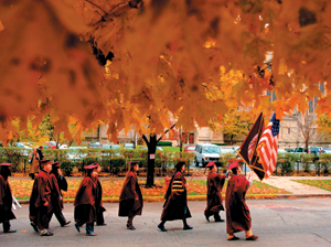 photo:  The 487th Convocation procession marches down University Avenue to a crowded Rockefeller Chapel. 