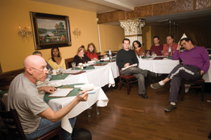 photo: Feldman (at center, in dark sweater) moderates an October meeting at Odéon Café.