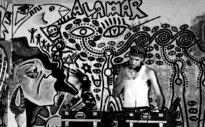 photo: Against a graffiti-art backdrop, a DJ spins records at the Alamar hip-hop festival in 2001. 