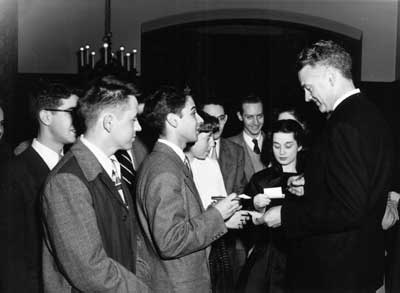 IMAGE: Chancellor Robert Maynard Hutchins-"the rock star," as Lewellyn calls him today-signs autographs for students at his January 10, 1951, farewell party. Lewellyn remembers maneuvering to get both Hutchins's and the students' faces to show in the photo. "The students were so enchanted with him," he says.