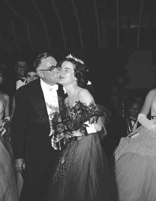 IMAGE:  Chancellor Lawrence Kimpton kisses "Miss U of C" Jeanine Johnson, AB'56, AB'58, at the February 25, 1956, Washington prom.