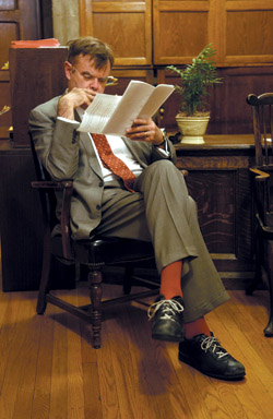 photo: Garrison Keillor—in his famous footwear—checks his notes before his talk.