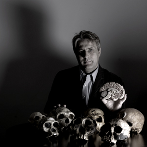 photo:  The capacity to separate self from other is a key component of empathy; otherwise, the sight of another's pain can become paralyzing, says neuros cientist Jean Decety, here with his collected replicas of early hominid skulls.